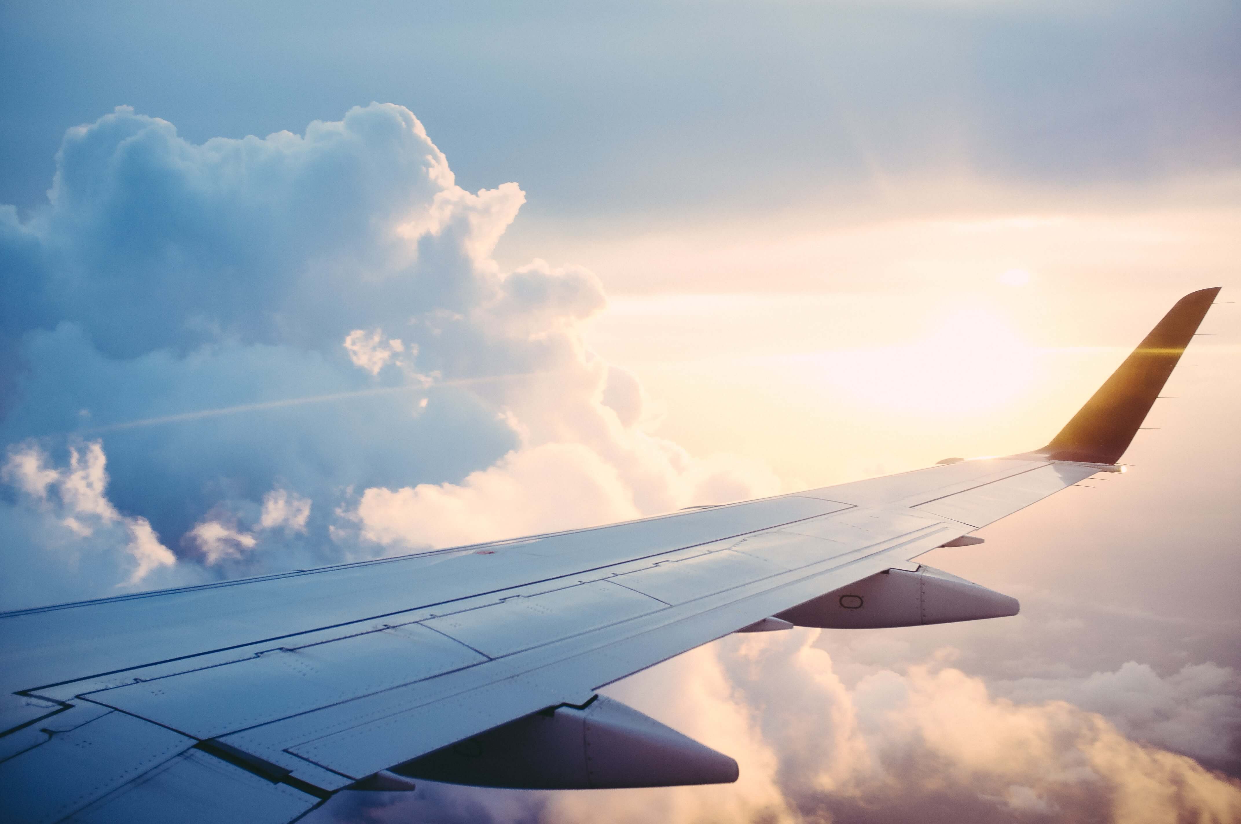 Airplane wing in the sky with clouds