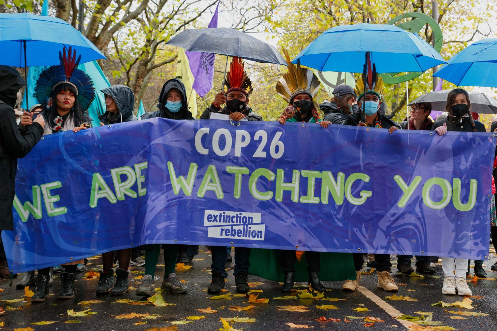 Native protestors holding banner that reads 