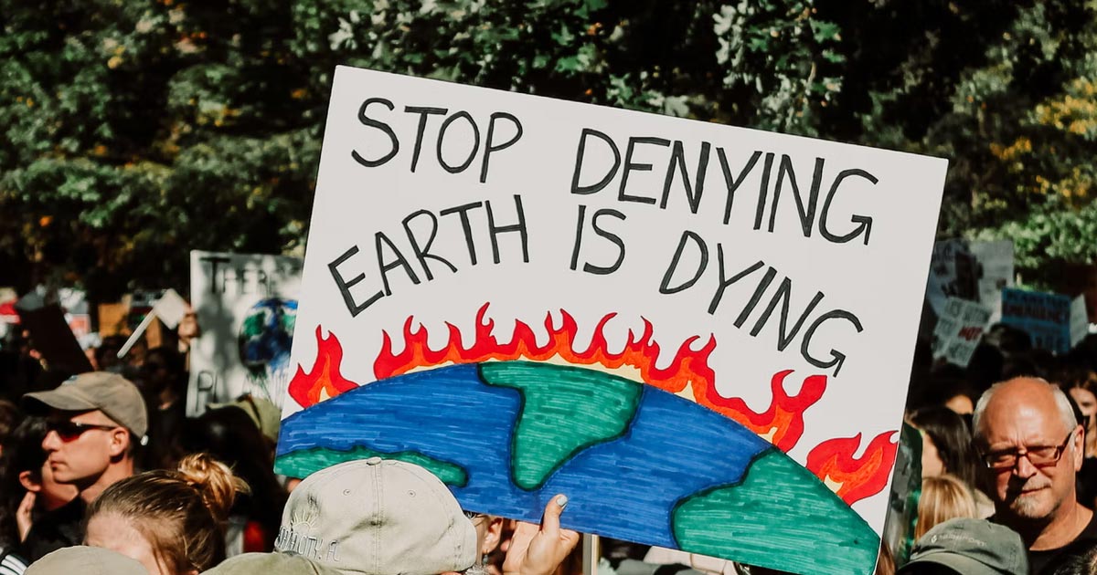 Protestor holds sign that reads 