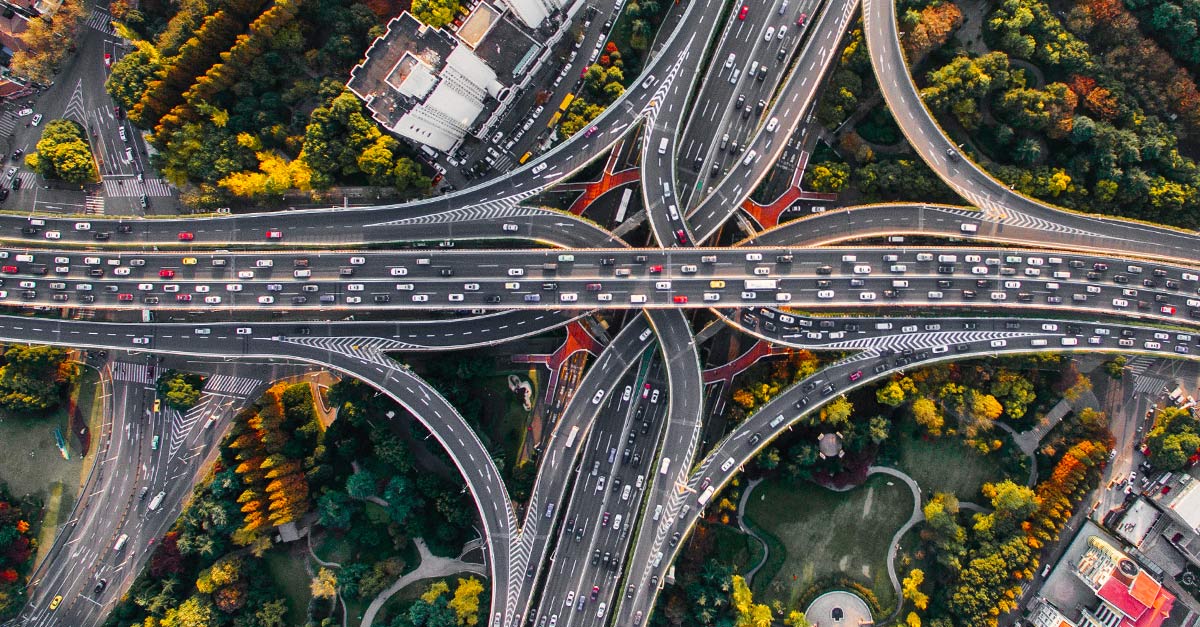 Aerial view of criss-crossing freeways full of automobiles and trucks